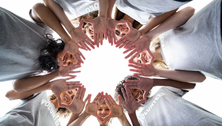 people's hands form a circle conveying BHI community commitment